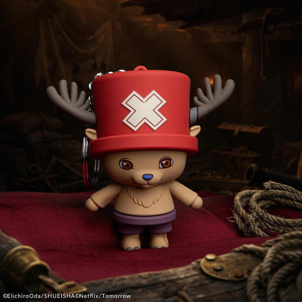 Officially licensed netflix One Piece Chopper Gomee Keymate keyring with his signature red hat and antlers on a dark wooden pirate deck by cinereplicas.