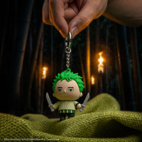 Officially licensed One Piece Zoro Gomee Keymate keyring held up in a bamboo forest background by Cinereplicas.