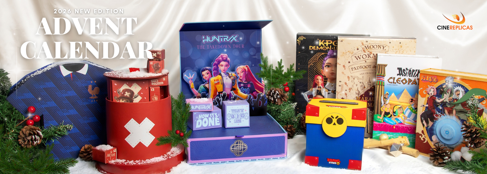 Promotion banner for Cinereplicas' 2026 New Edition Advent Calendars. A winter-themed holiday display on a white fabric backdrop featuring licensed advent calendars, including Harry Potter (Marauder's Map), One Piece (Tony Tony Chopper), KPop demon Hunters, Asterix & Cleopatra, Naruto, and Brawl Stars. The display is decorated with pine branches and pine cones, with '2026 NEW EDITION ADVENT CALENDAR' and the 'Cinereplicas' brand logo visible on top.